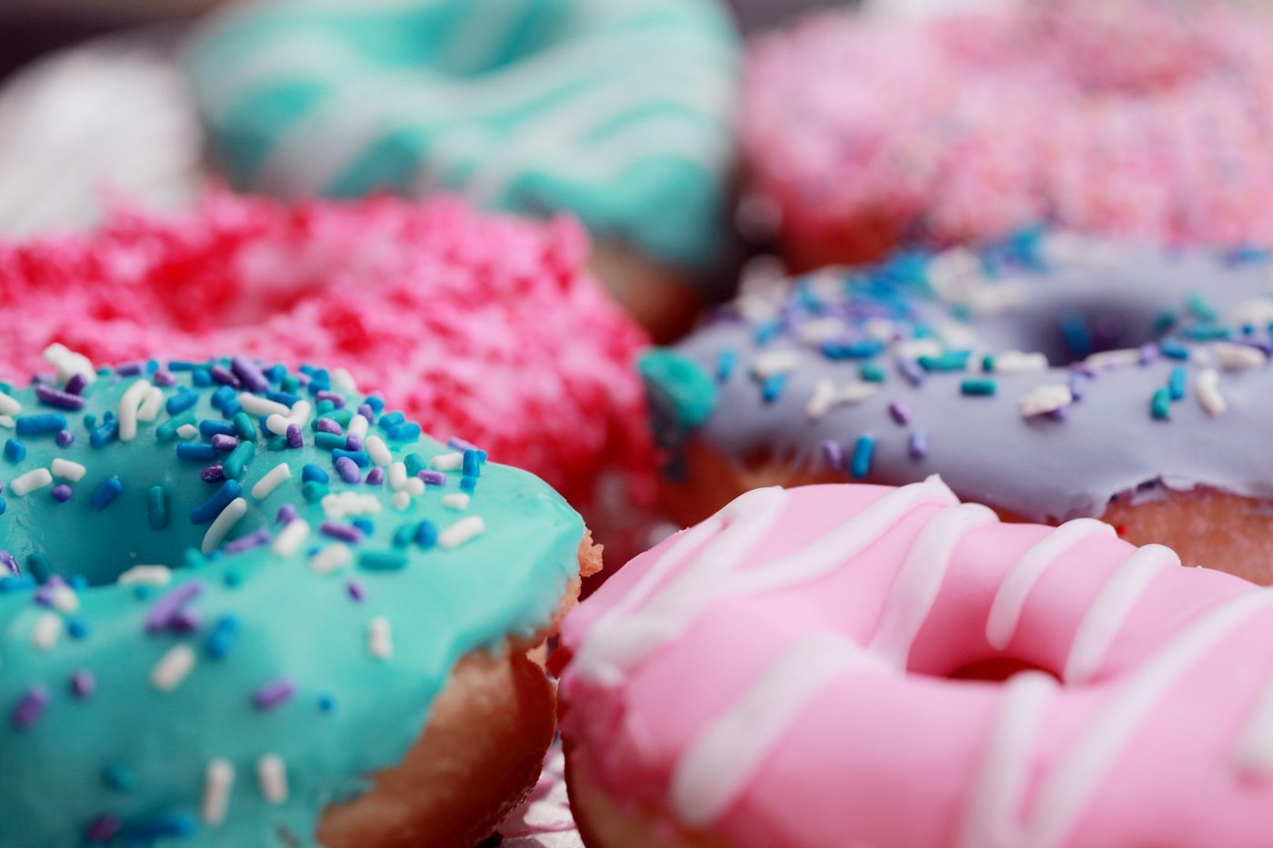 Pastel glazed doughnuts with sprinkles
